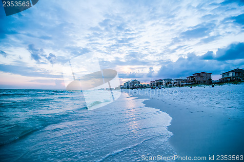 Image of sunset on florida beach with white sand and blue sky