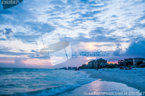 Image of sunset on florida beach with white sand and blue sky