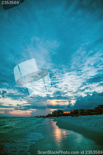 Image of sunset on florida beach with white sand and blue sky
