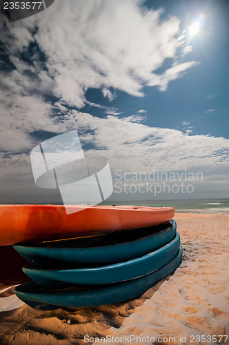 Image of kayaks on the beach at night