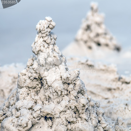 Image of sand castle structures built at seashore