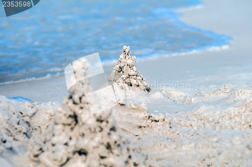 Image of sand castle structures built at seashore