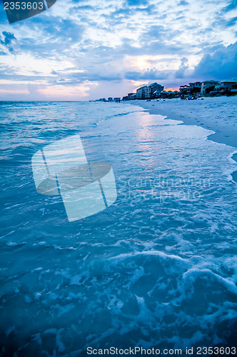 Image of sunset on florida beach with white sand and blue sky