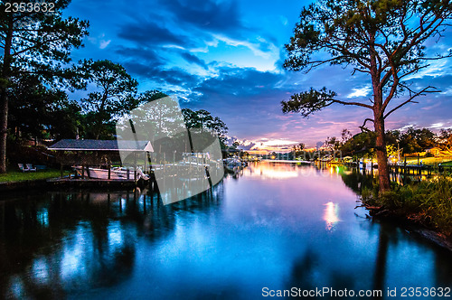 Image of A Very Colorful Mythical Sunset Over water way near ocean