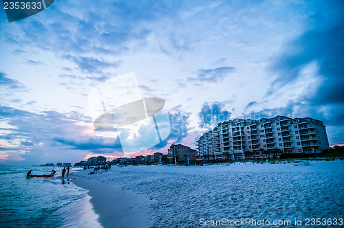 Image of sunset on florida beach with white sand and blue sky