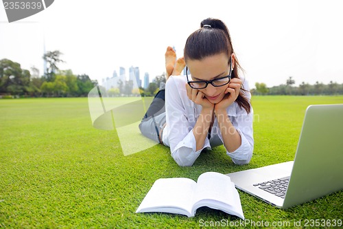 Image of woman with laptop in park