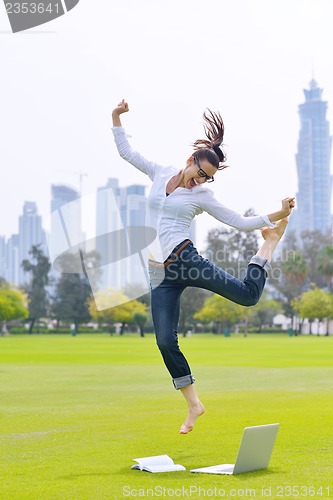 Image of woman with laptop in park