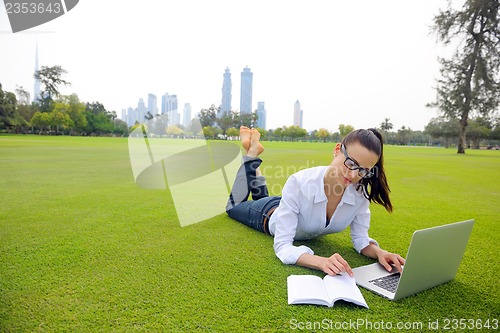 Image of woman with laptop in park