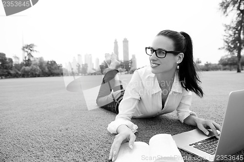 Image of woman with laptop in park