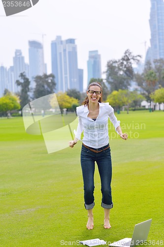 Image of woman with laptop in park