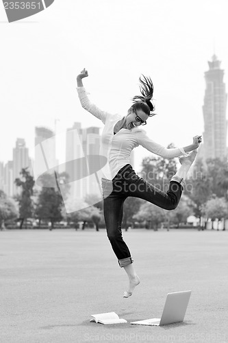 Image of woman with laptop in park