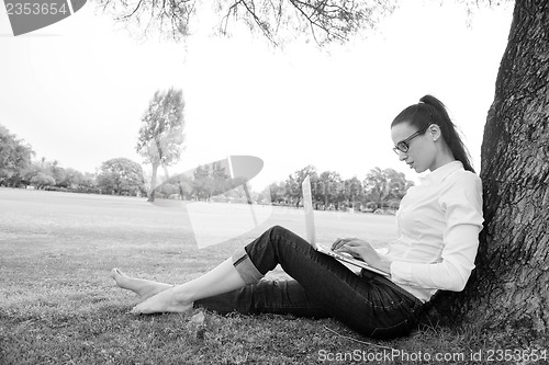 Image of woman with laptop in park