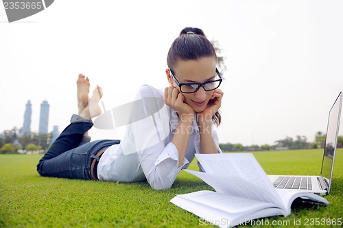 Image of woman with laptop in park