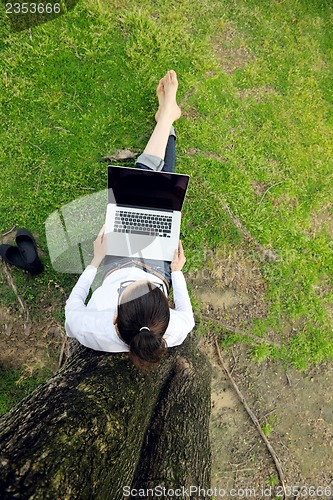 Image of woman with laptop in park