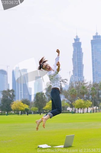 Image of woman with laptop in park