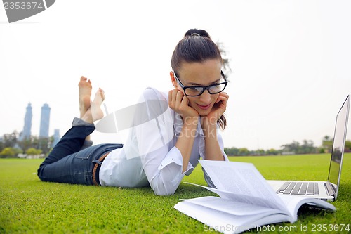 Image of woman with laptop in park
