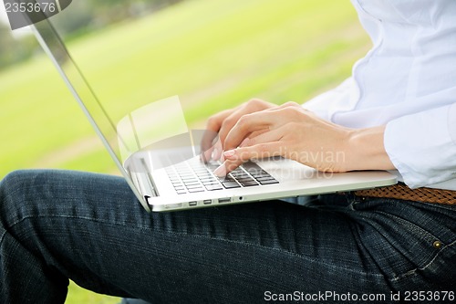 Image of woman with laptop in park