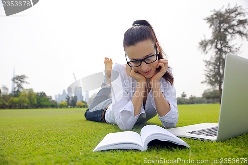 Image of woman with laptop in park