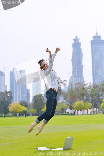 Image of woman with laptop in park