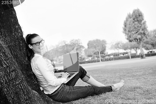 Image of woman with laptop in park
