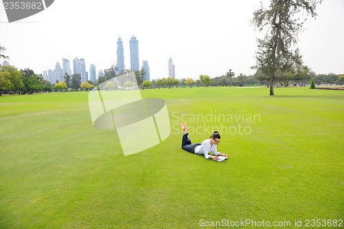 Image of woman with laptop in park