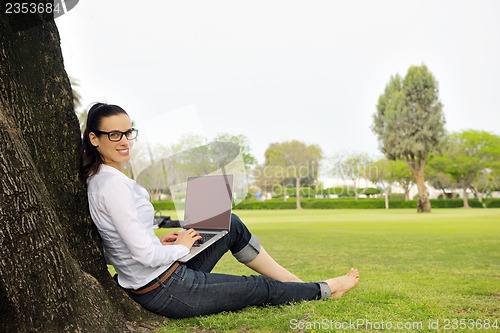 Image of woman with laptop in park