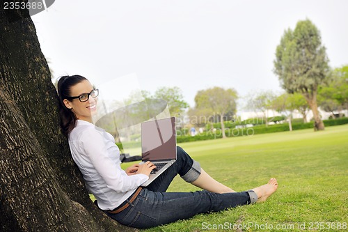 Image of woman with laptop in park