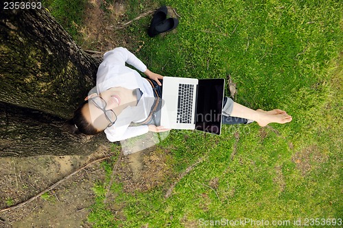 Image of woman with laptop in park