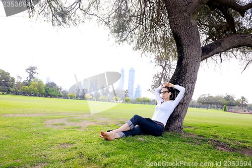 Image of Beautiful young woman with  tablet in park