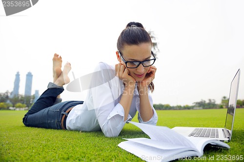 Image of woman with laptop in park
