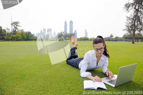 Image of woman with laptop in park