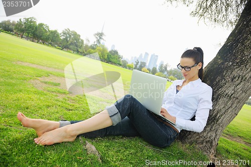 Image of woman with laptop in park