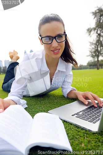 Image of woman with laptop in park
