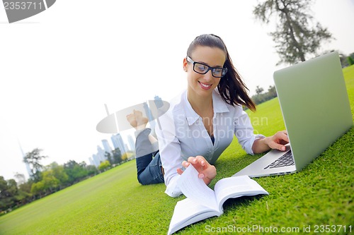 Image of woman with laptop in park