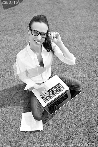 Image of woman with laptop in park