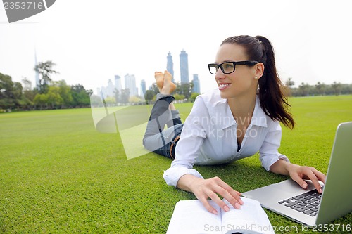 Image of woman with laptop in park