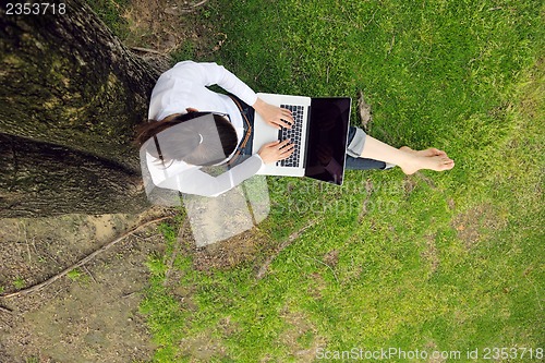 Image of woman with laptop in park