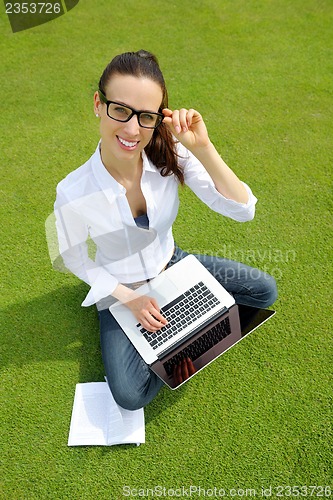 Image of woman with laptop in park