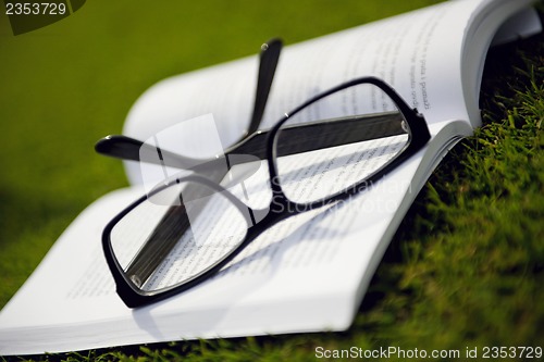 Image of Glasses on a book outside with grass