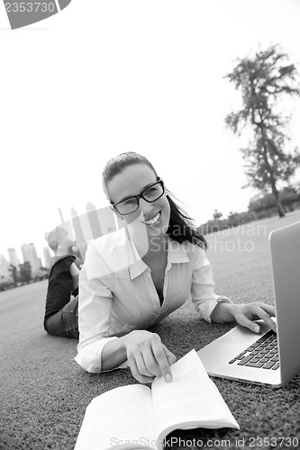 Image of woman with laptop in park