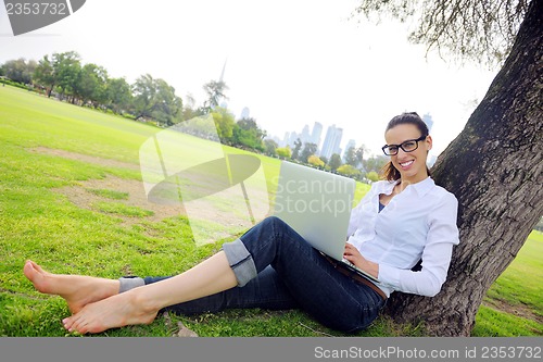 Image of woman with laptop in park