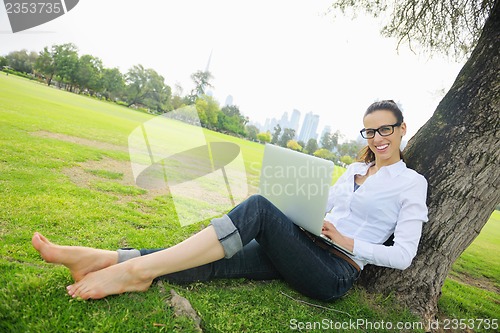 Image of woman with laptop in park