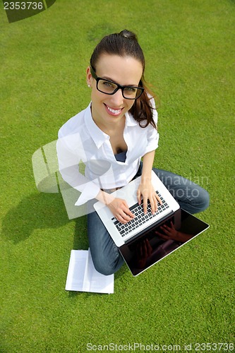 Image of woman with laptop in park