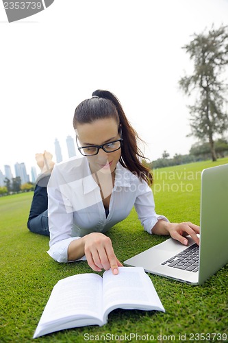 Image of woman with laptop in park