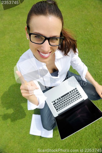 Image of woman with laptop in park