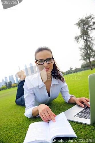 Image of woman with laptop in park