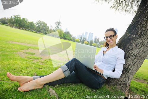 Image of woman with laptop in park