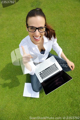 Image of woman with laptop in park
