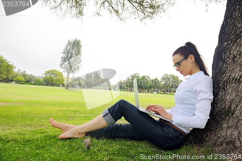 Image of woman with laptop in park