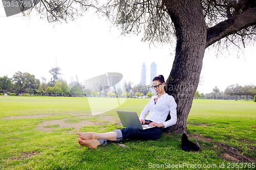 Image of woman with laptop in park